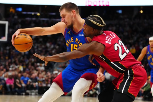 Nov 8, 2024; Denver, Colorado, USA; Miami Heat forward Jimmy Butler (22) defends Denver Nuggets center Nikola Jokic (15) in the first quarter at Ball Arena. Mandatory Credit: Ron Chenoy-Imagn Images