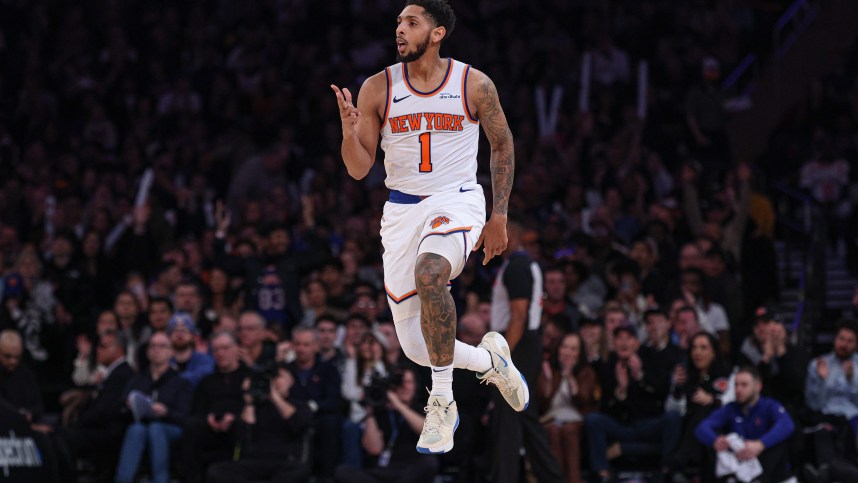 Jan 1, 2025; New York, New York, USA; New York Knicks guard Cameron Payne (1) reacts after a three point basket during the first half against the Utah Jazz at Madison Square Garden. Mandatory Credit: Vincent Carchietta-Imagn Images